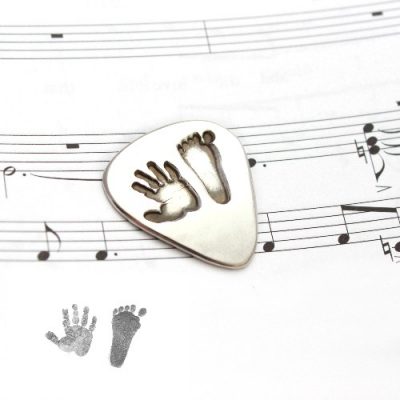 silver hand and footprint guitar pick