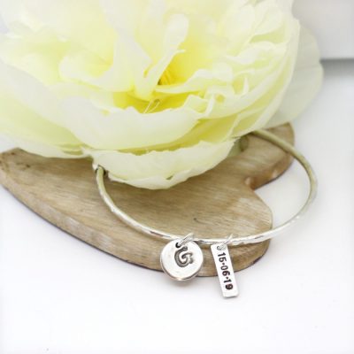 silver bangle and silver date charm